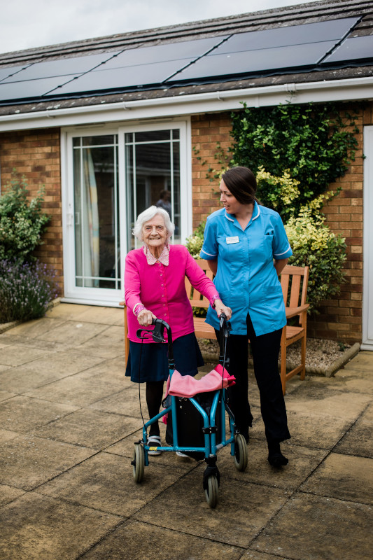 Elderly and Dementia care homes -Resident and carer taking a stroll